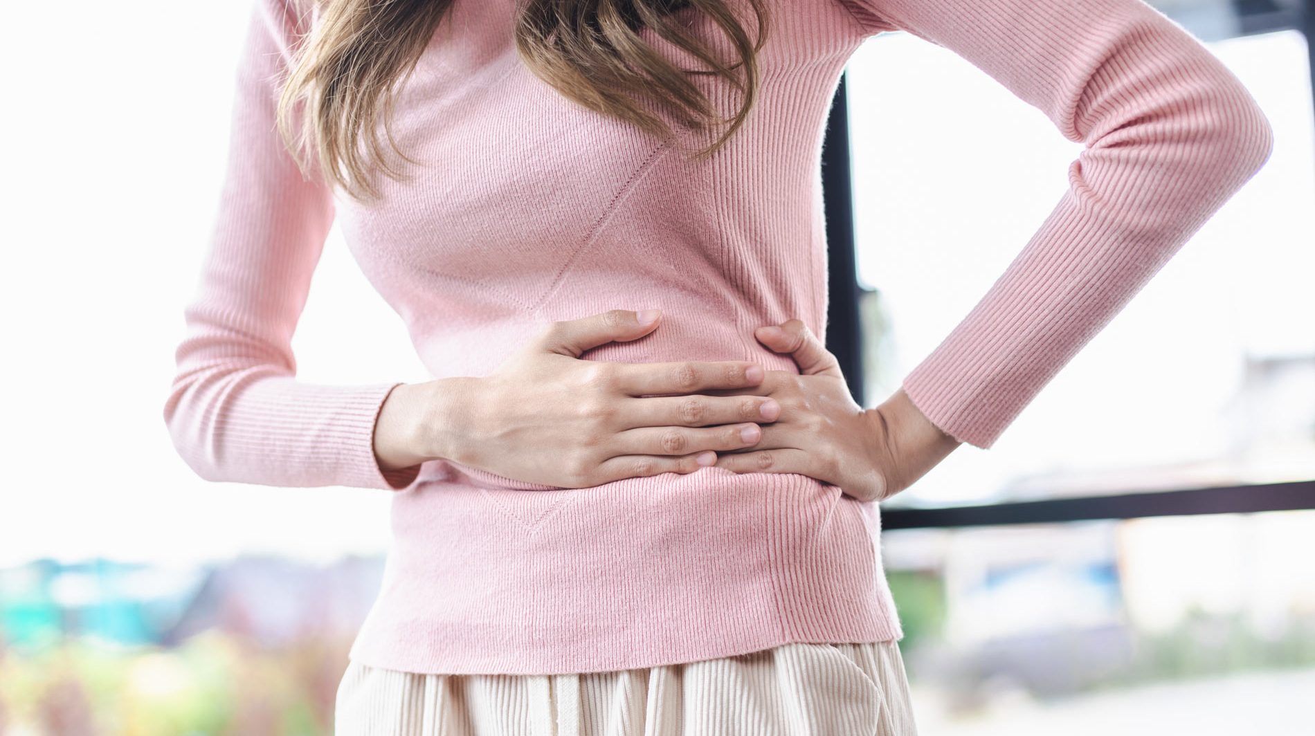 woman holding her stomach