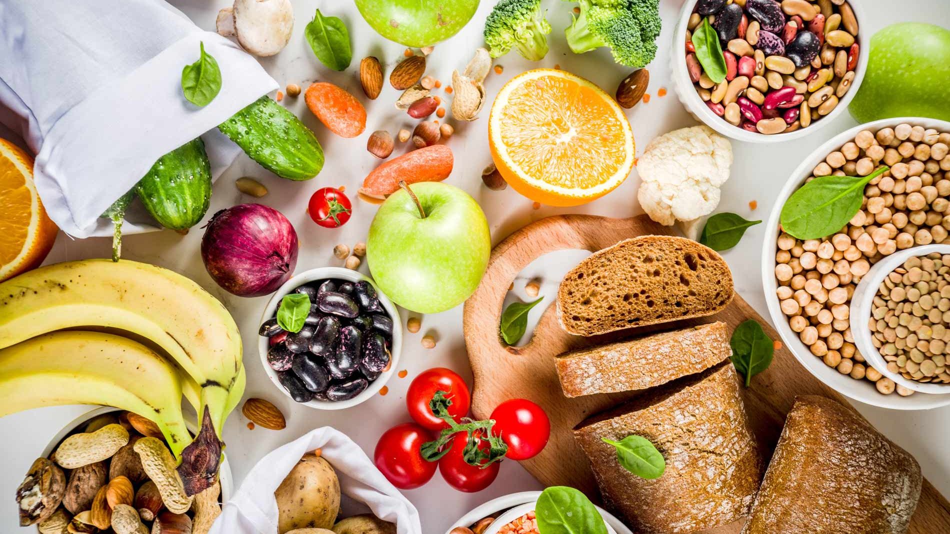 spread of fruits veggies bread and legumes