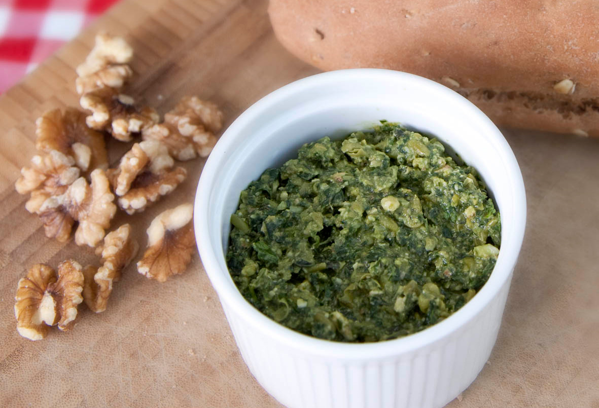 thick pesto paste in a little bowl with walnuts next to it