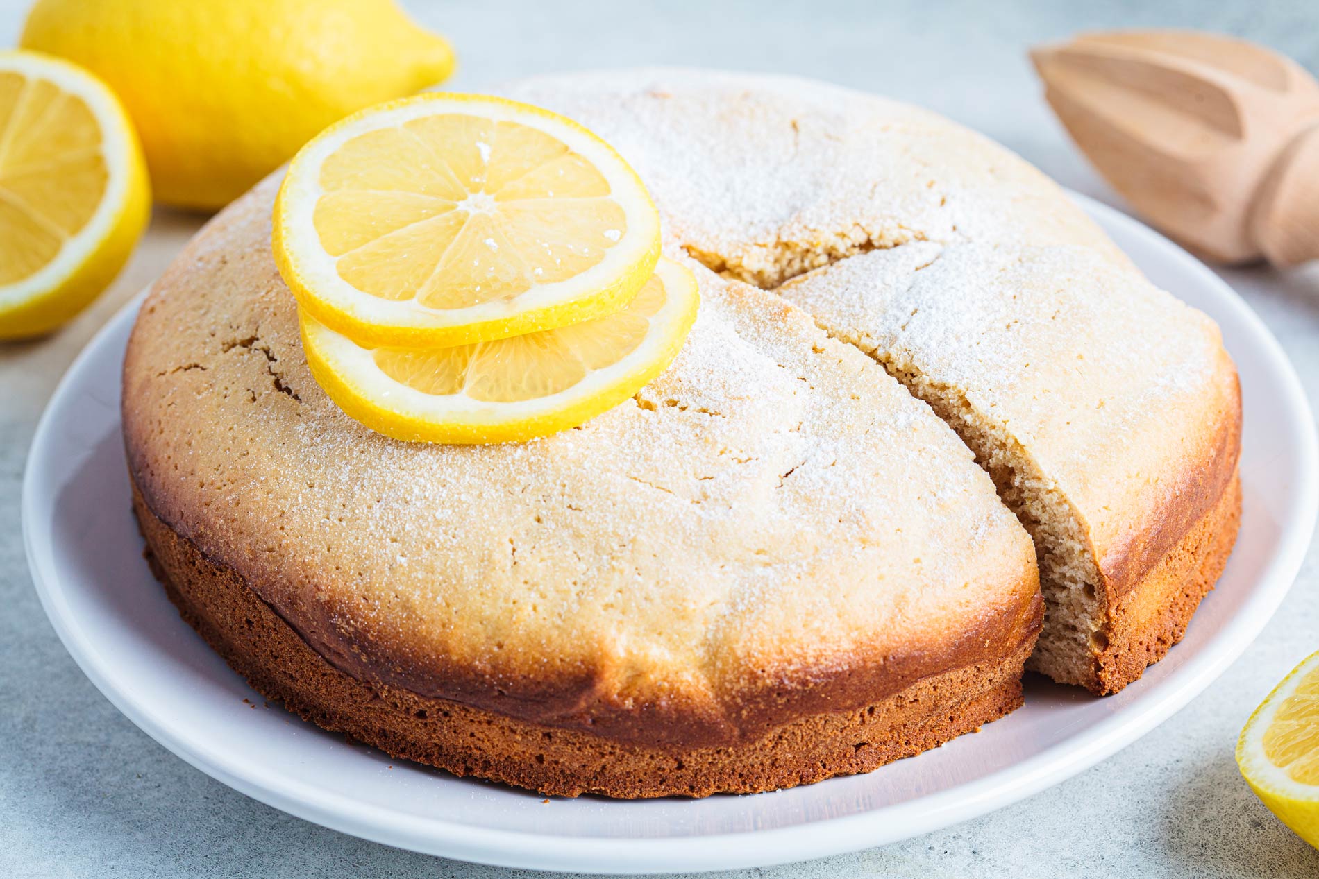 a whole round cake with slices of lemon on top