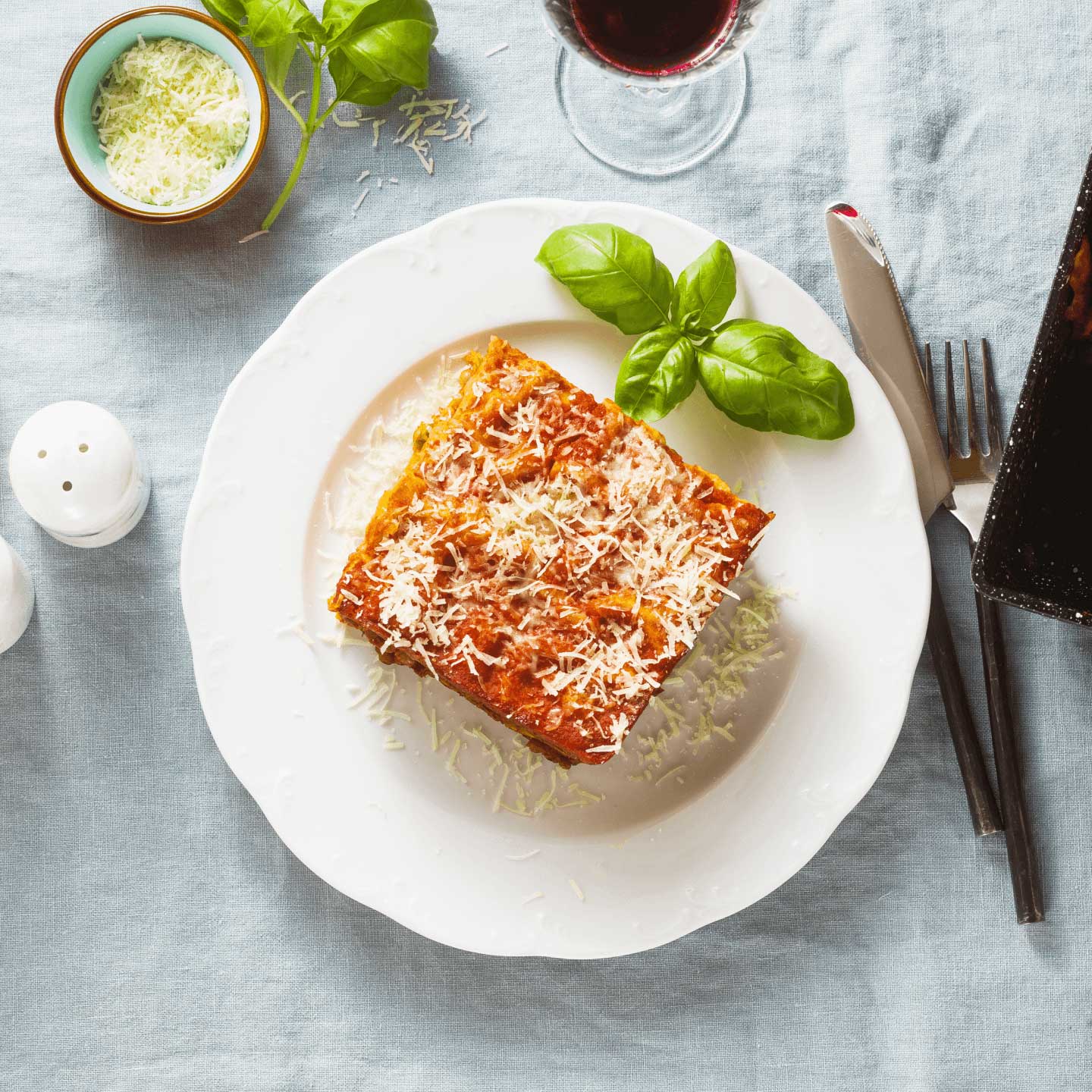 a slice of vegan lasagna with vegan cheese on a plate