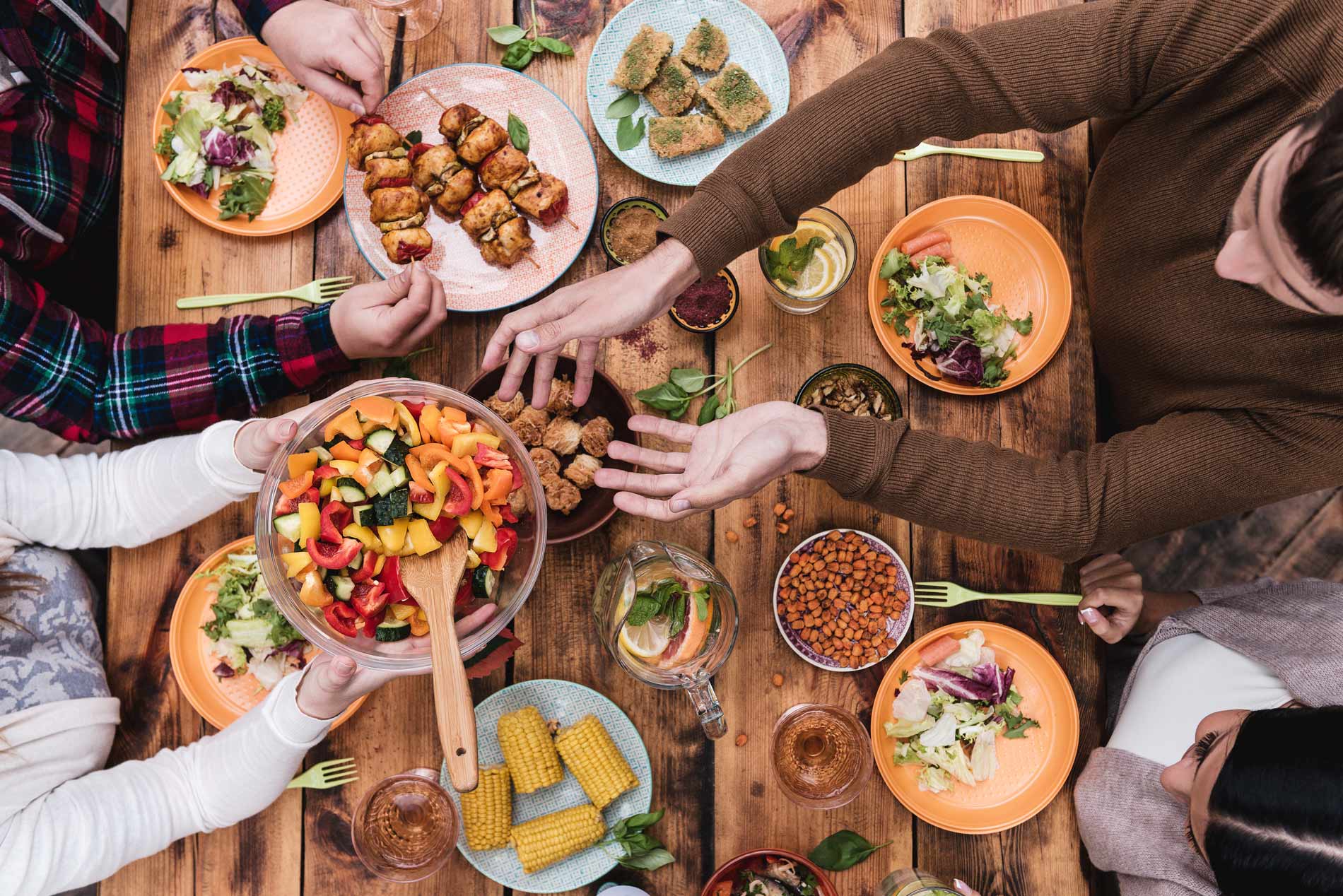 people sharing a spread of vegan food