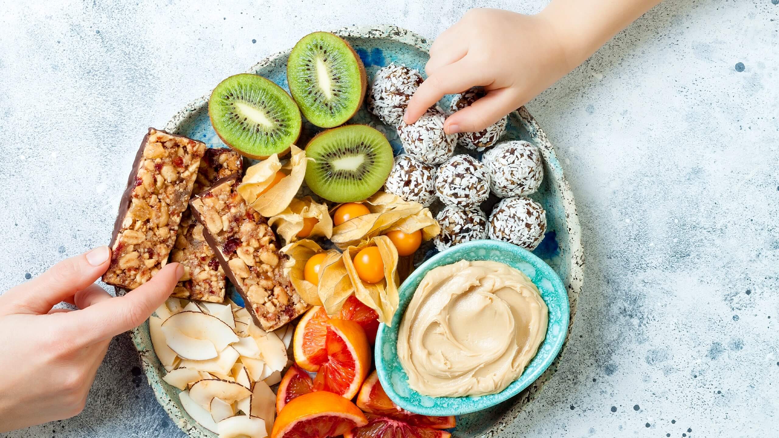 a plate with vegan homemade snacks and fruits