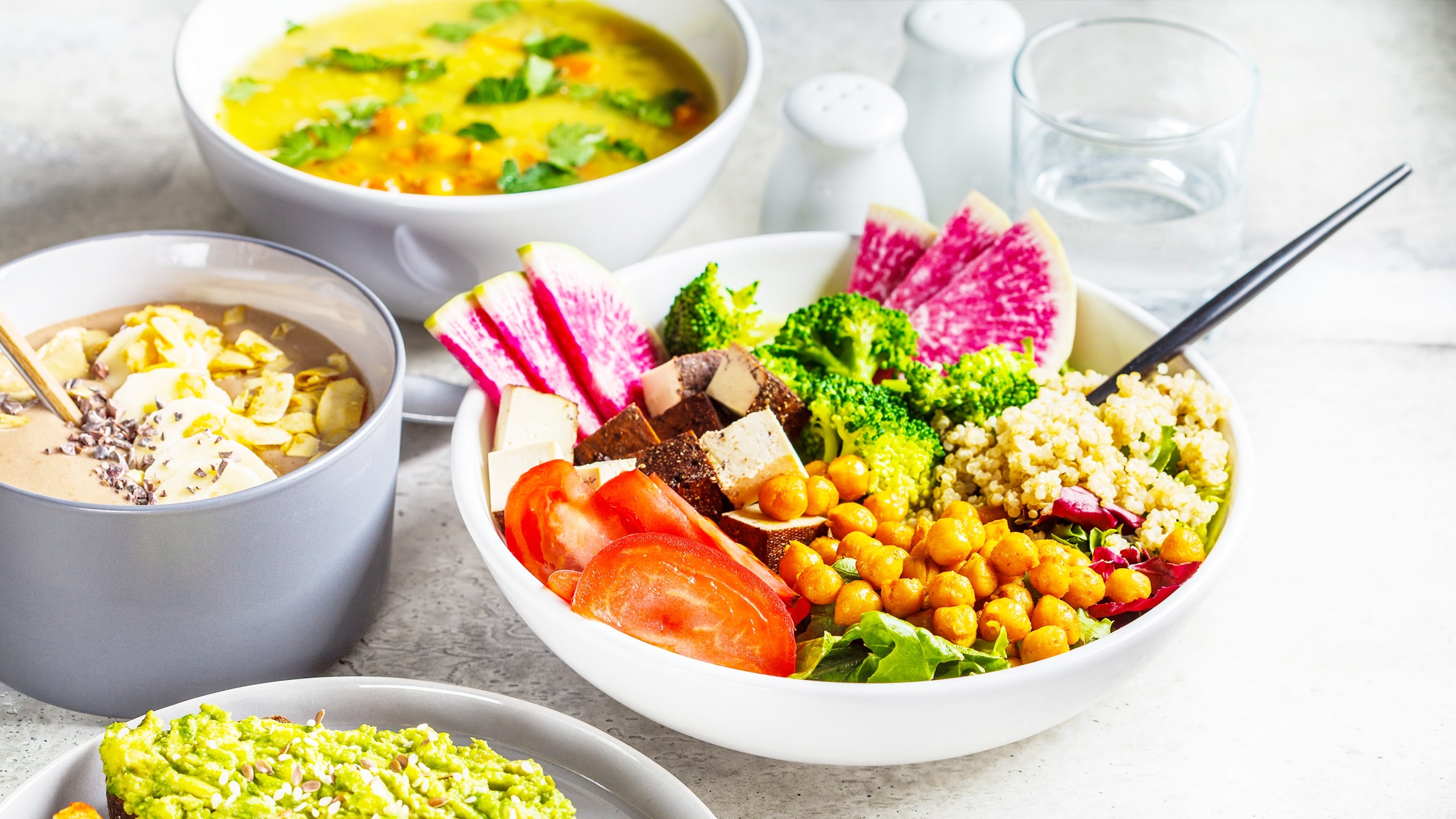 a spread of bowls of rich colorful and versetile vegan food