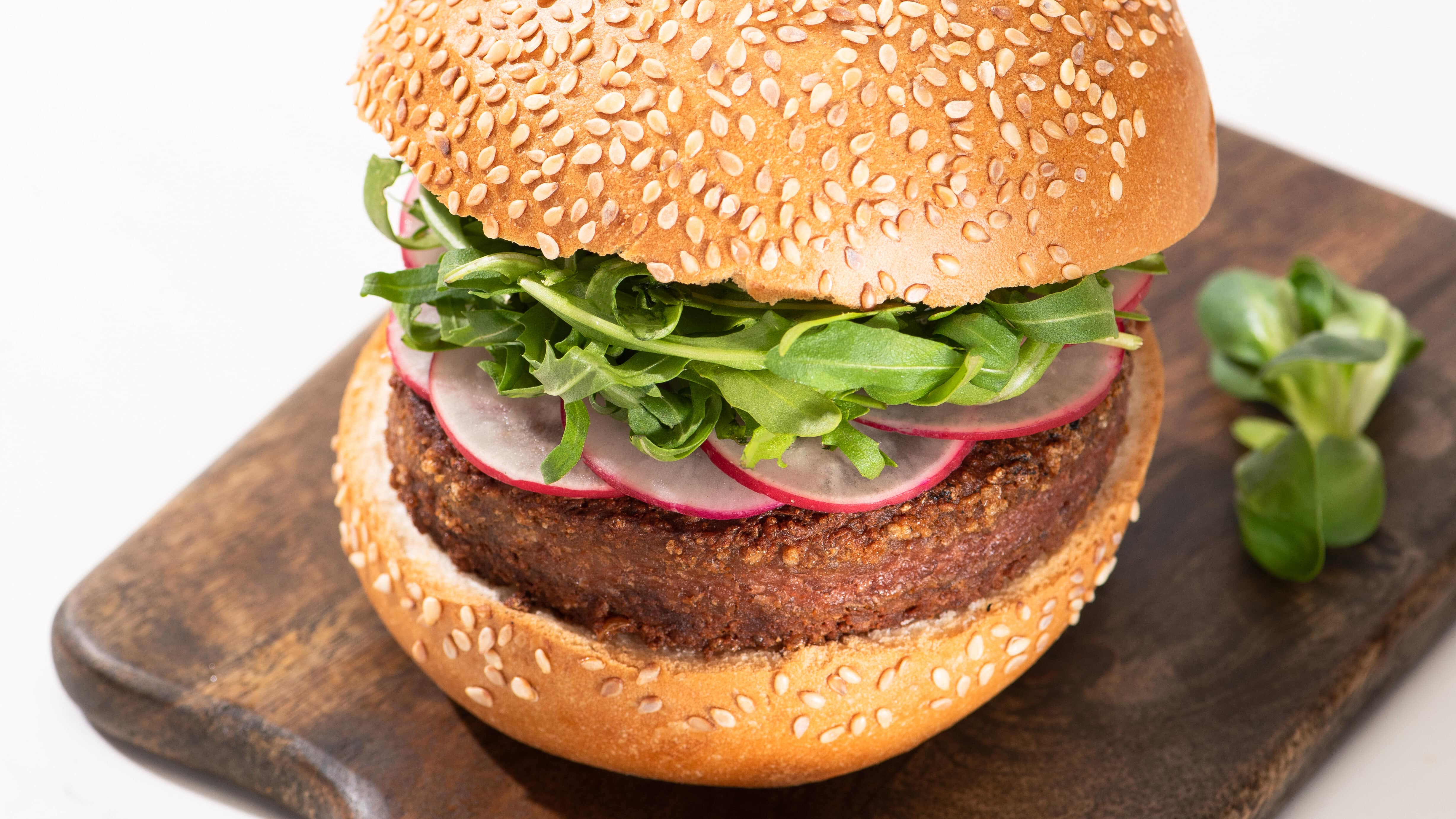 vegan burger patty in a burger bun with vegetables