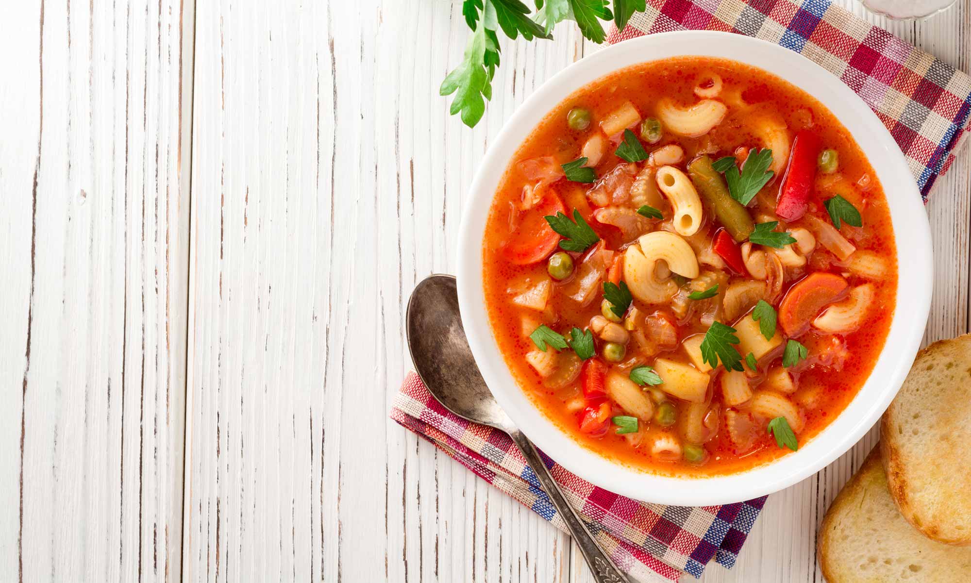 a bowl of minestrone - tomato soup with pasta and vegetables