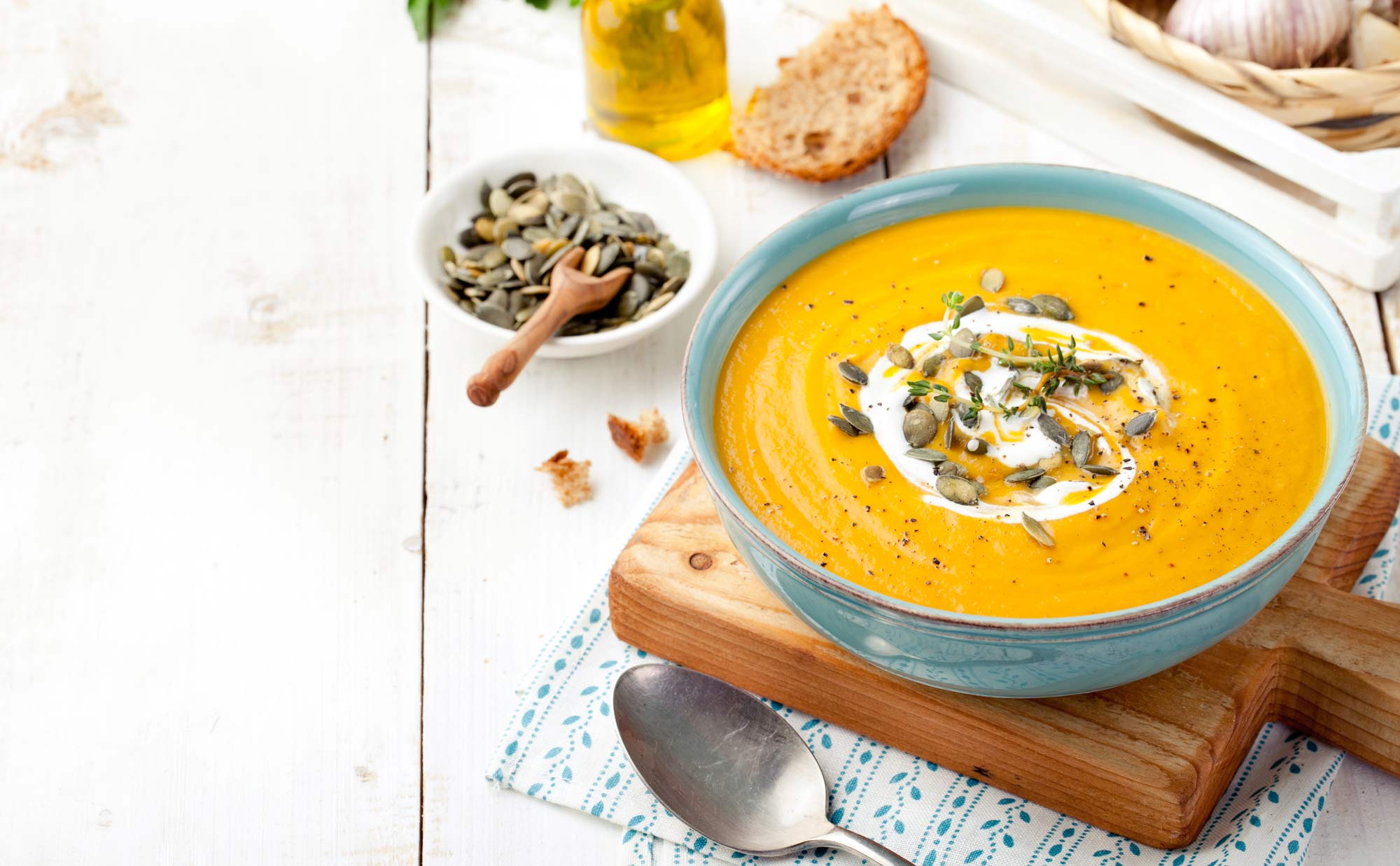 thick pumpkin soup in a bowl topped with pumpkin seeds