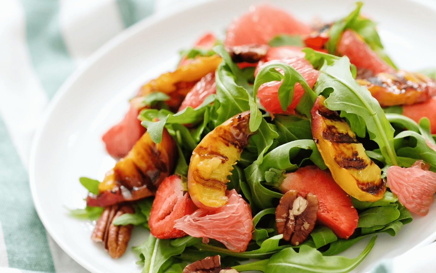 colorful salad of leaves, peaches and nuts