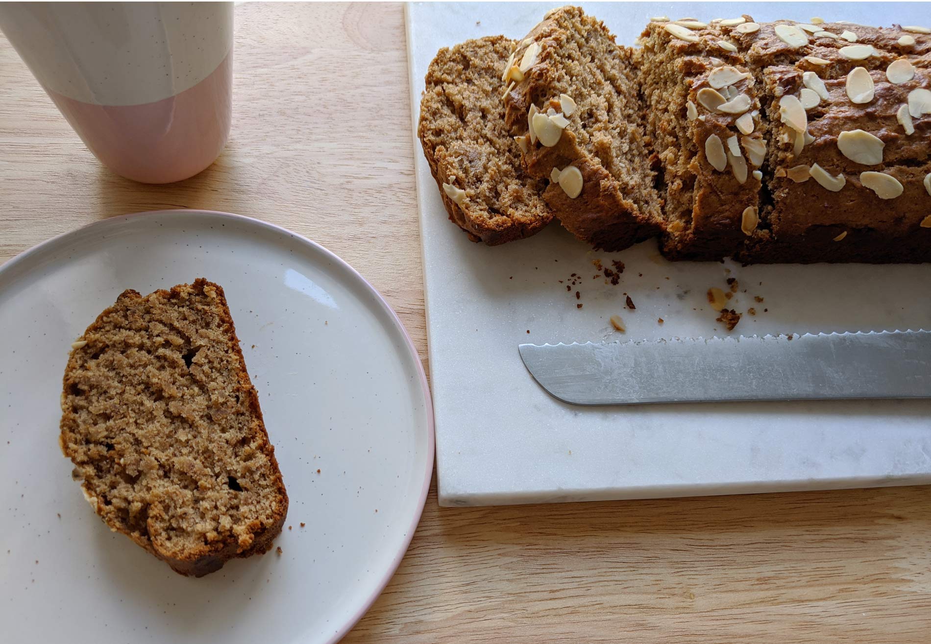 banana bread loaf with a slice on a plate