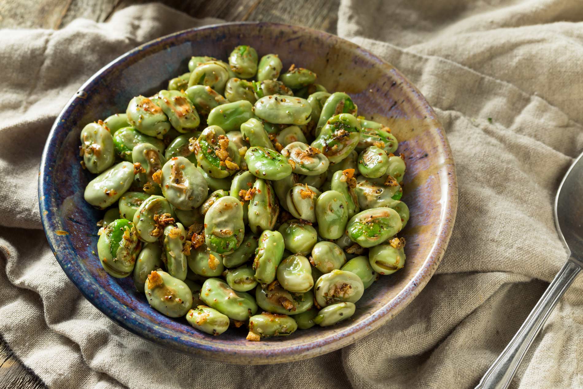 cooked beans in a bowl with olive oil and spices