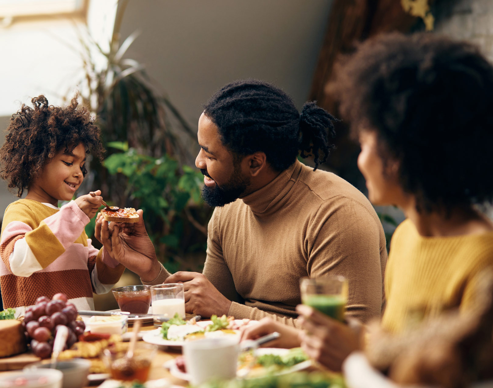 family sitting and eating around the table