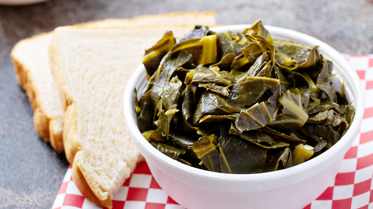 cooked collard greens next to two pieces of white bread