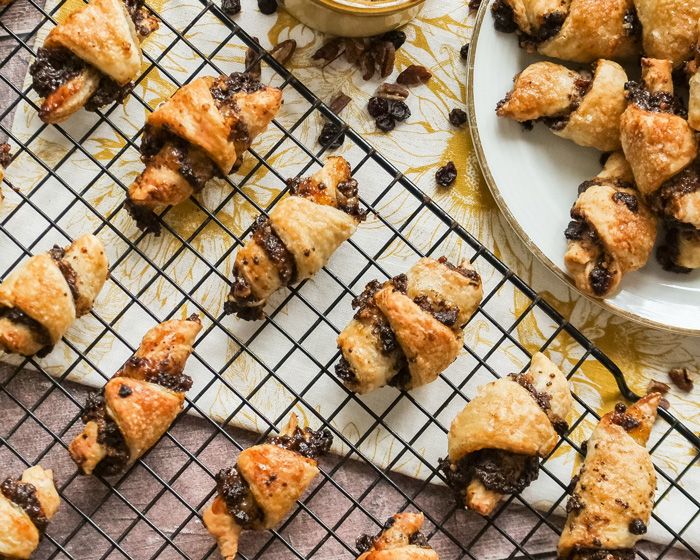 small home made rugelach pastries spread on a cooling rack